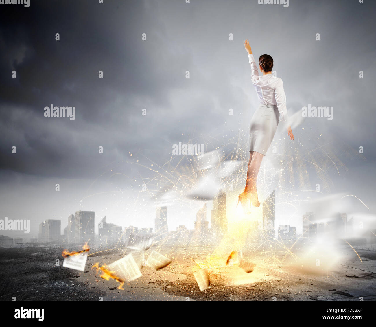 Image of businesswoman flying up into sky Stock Photo - Alamy