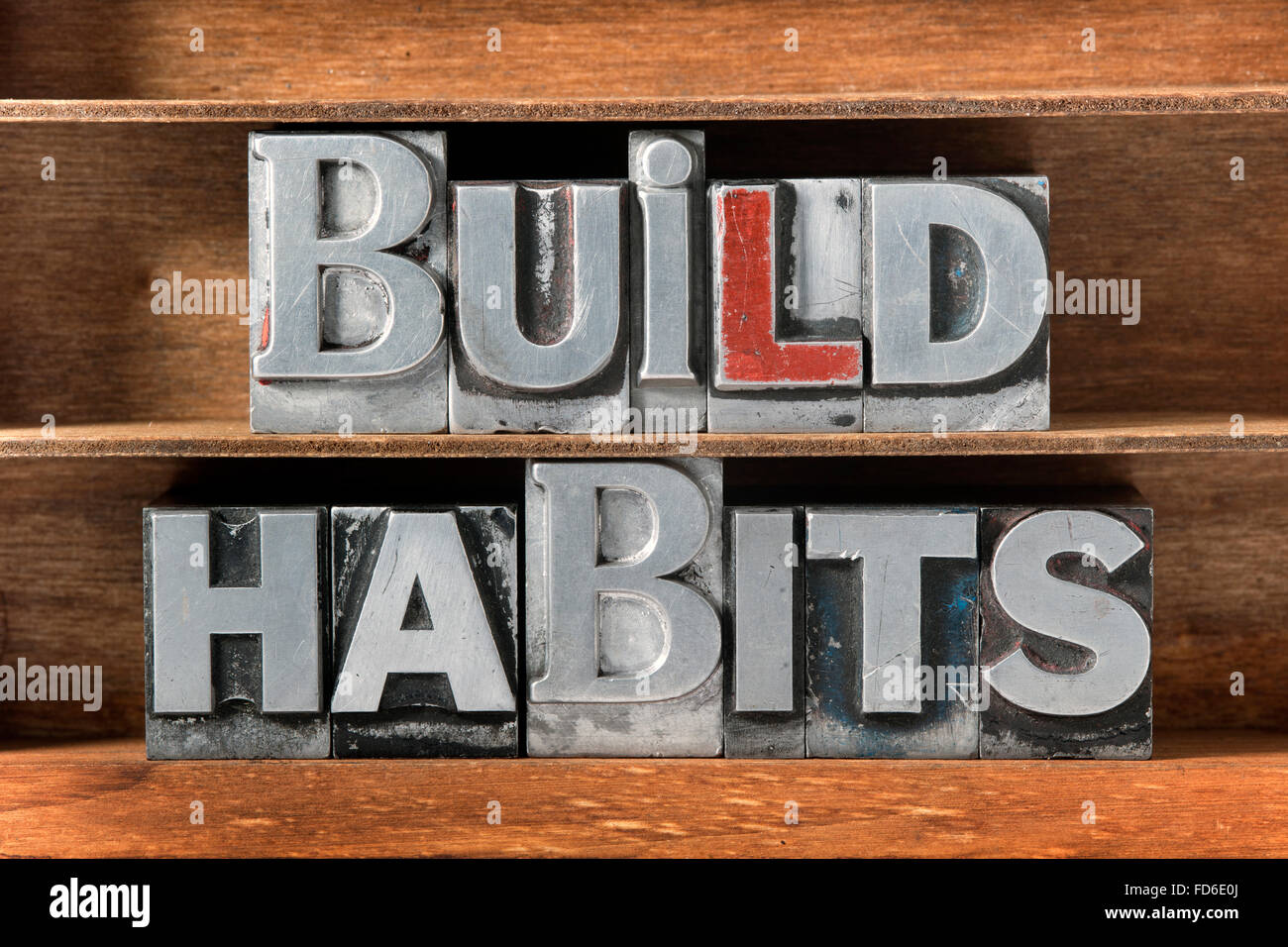 build habits phrase made from metallic letterpress type on wooden tray Stock Photo