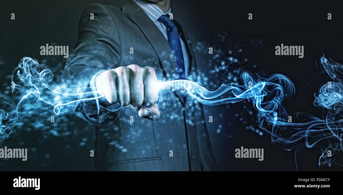 Businessman holding fire flames in fist. Power and control Stock Photo