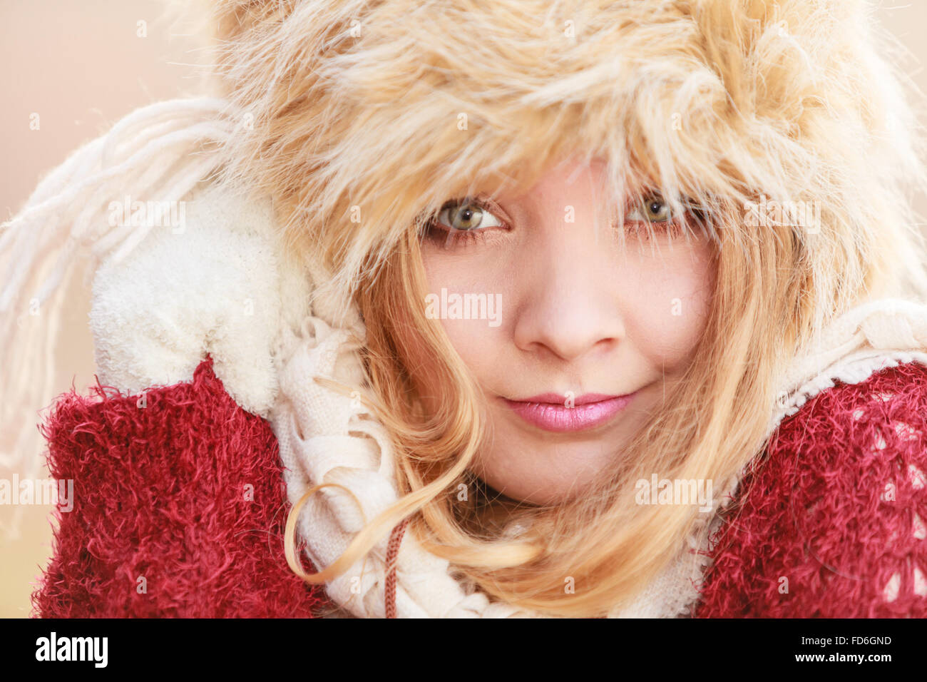 Portrait of pretty smiling fashionable woman. Happy gorgeous young girl in fur winter hat. Autumn fall fashion. Stock Photo