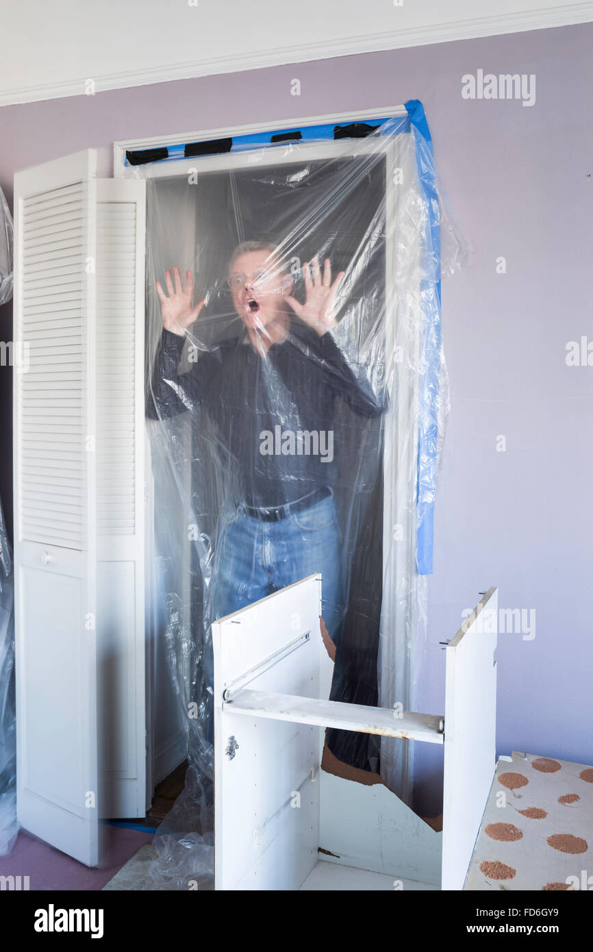 Man Running Into Plastic Sheet, Apartment under Renovation in New York City, USA Stock Photo