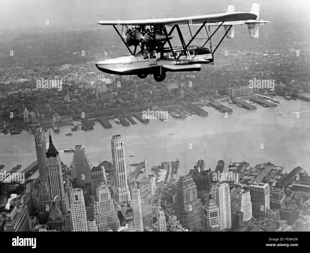 Amphibian flying over New York City, 1932 Stock Photo