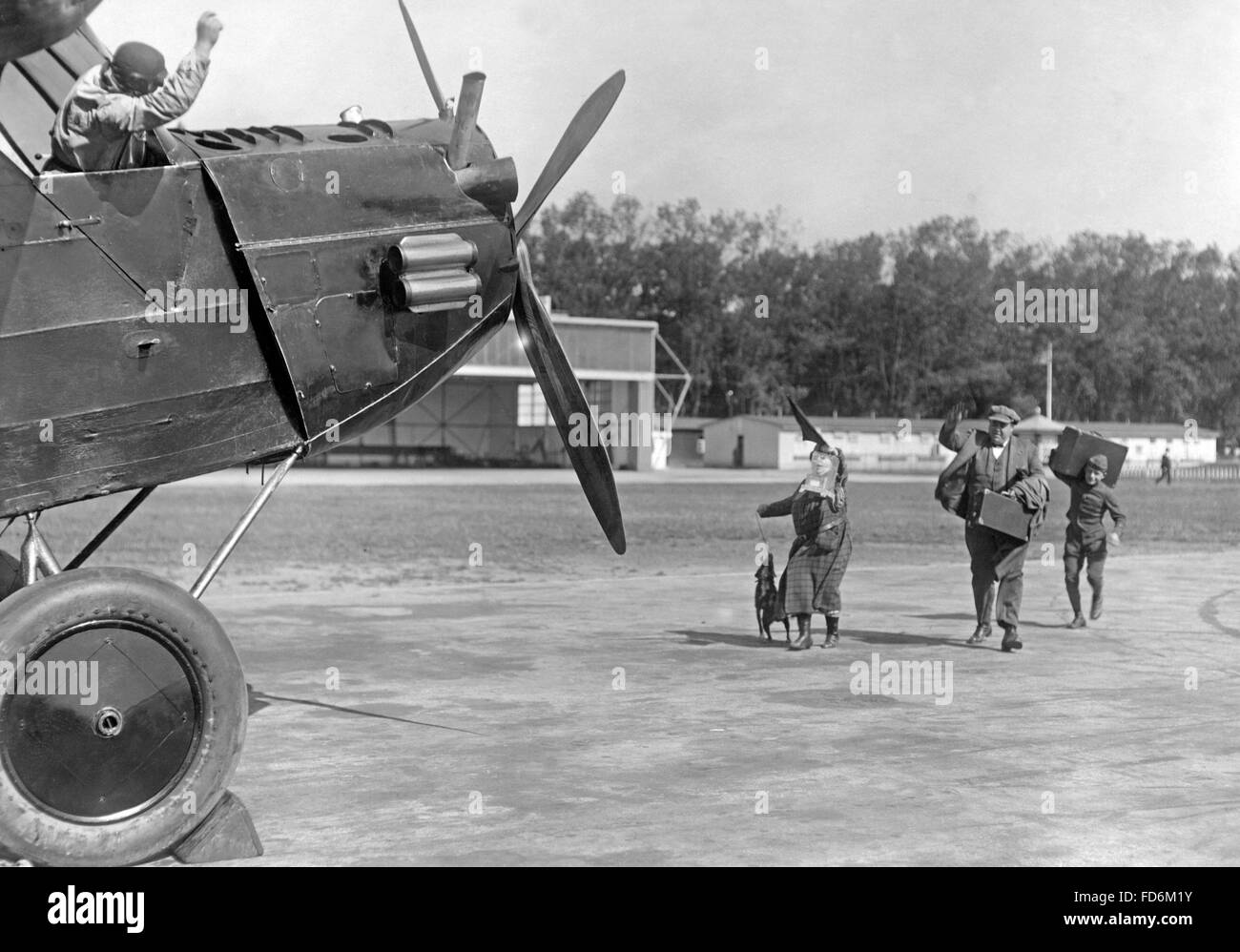 Family rushing to a prop airliner, ca. 1920s Stock Photo