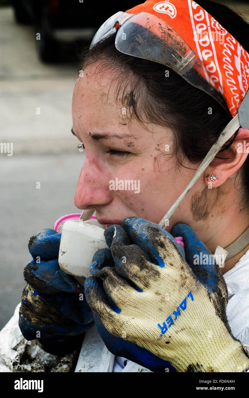 Volunteers in full protective gear strip heavily molded drywall and