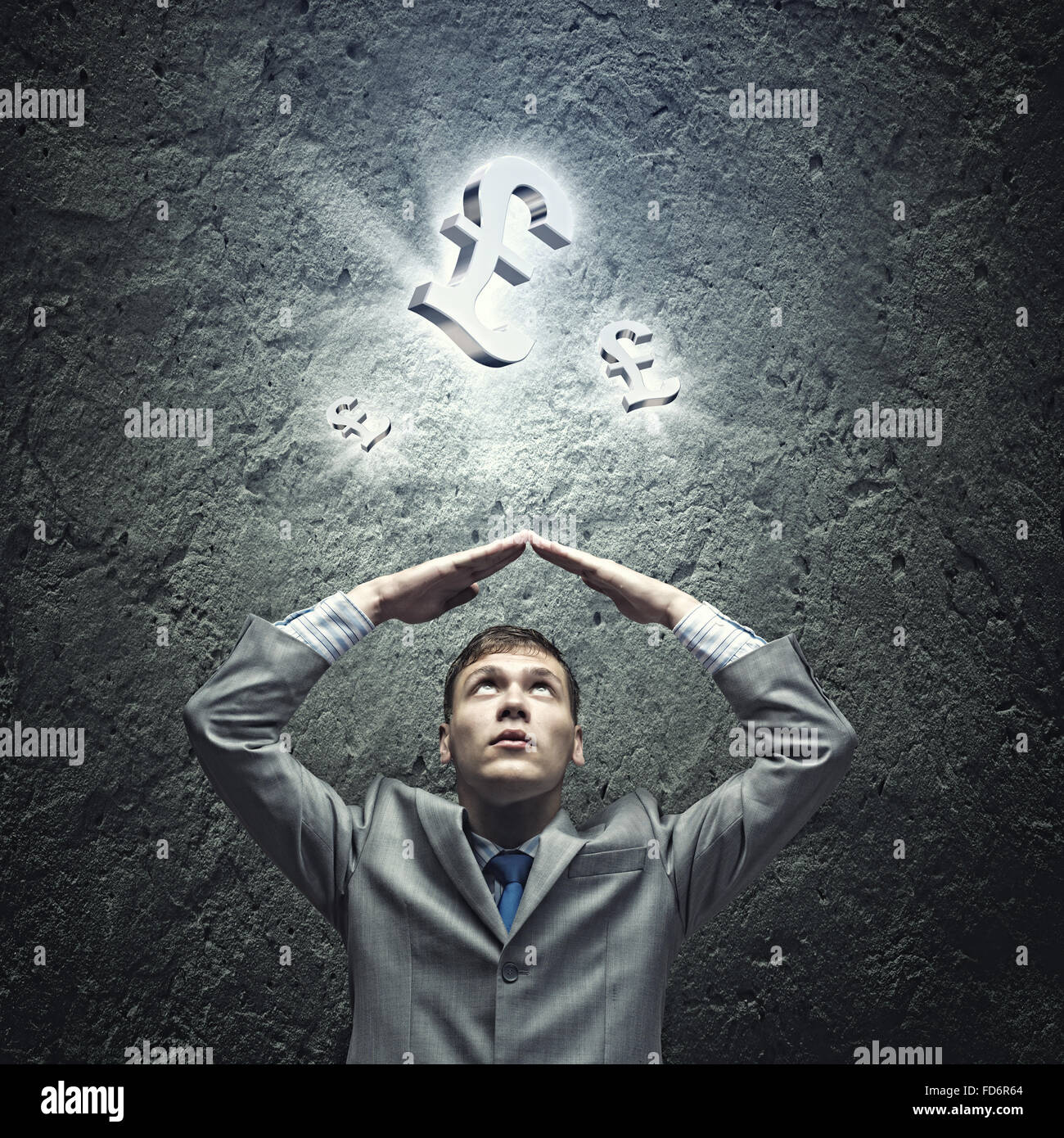 Young businessman Holding arms above head. Money concept Stock Photo