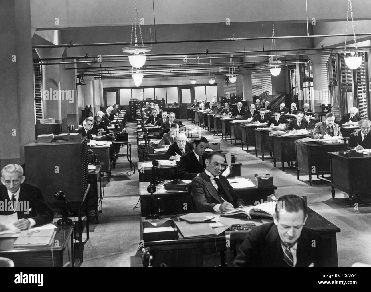 Employees at the desk, 1930s Stock Photo