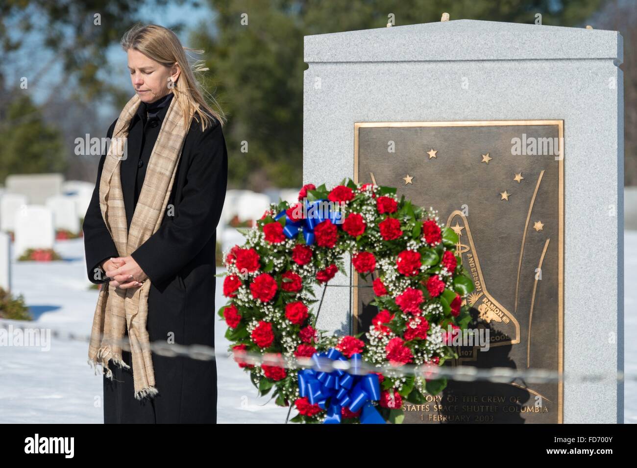 Arlington, Virginia, USA. 28th January, 2016. NASA Deputy Administrator Dava Newman bows her head after placing a wreath at the Space Shuttle Challenger Memorial as part of NASA's Day of Remembrance on the 30th anniversary of the Challenger explosion at Arlington National Cemetery January 28, 2016 in Arlington, Virginia. The wreaths were placed in memory of those men and women who lost their lives in the quest for space exploration. Stock Photo