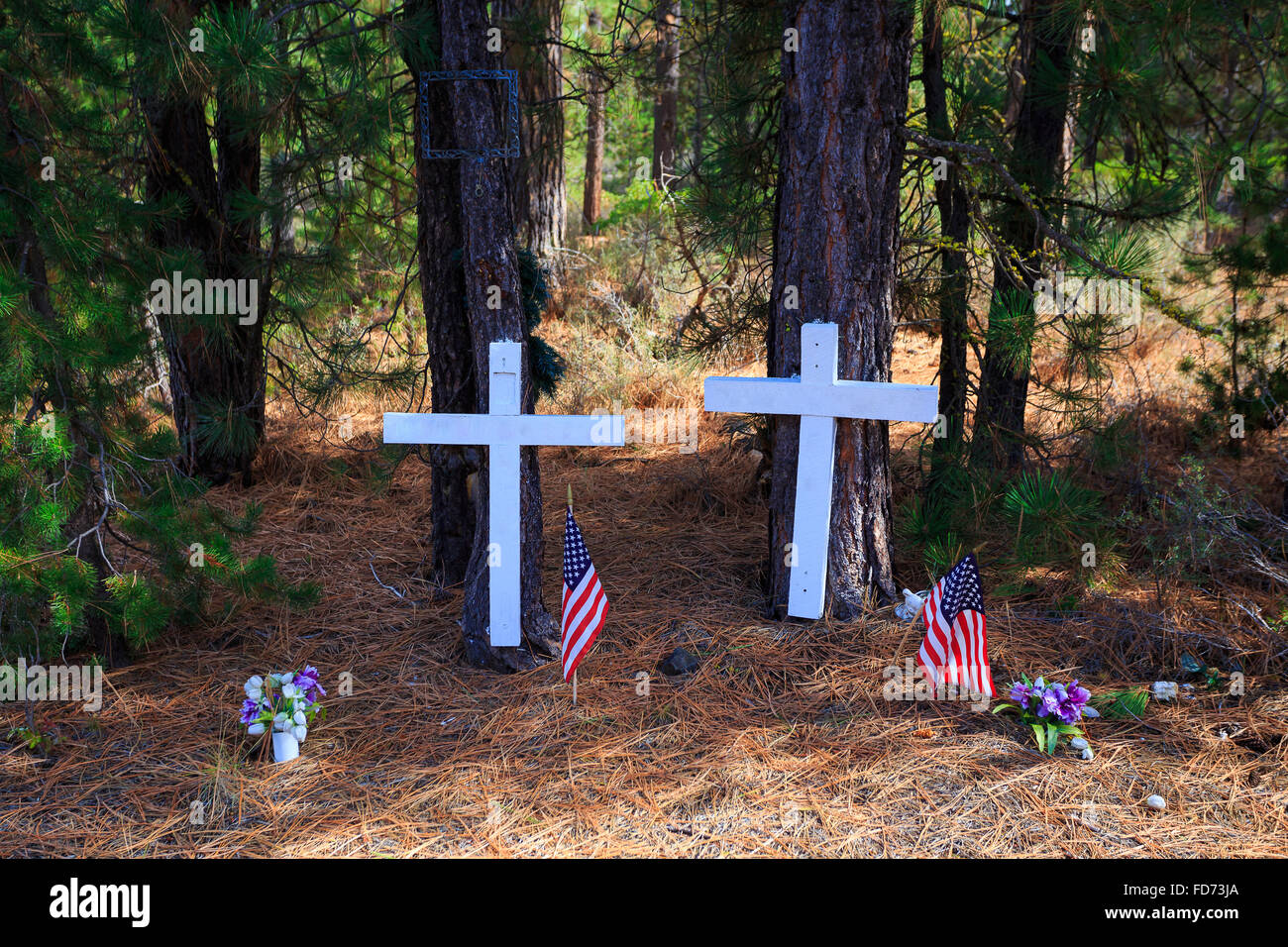 White crosses show where two people have died in a traffic accident on the highway years ago. Stock Photo