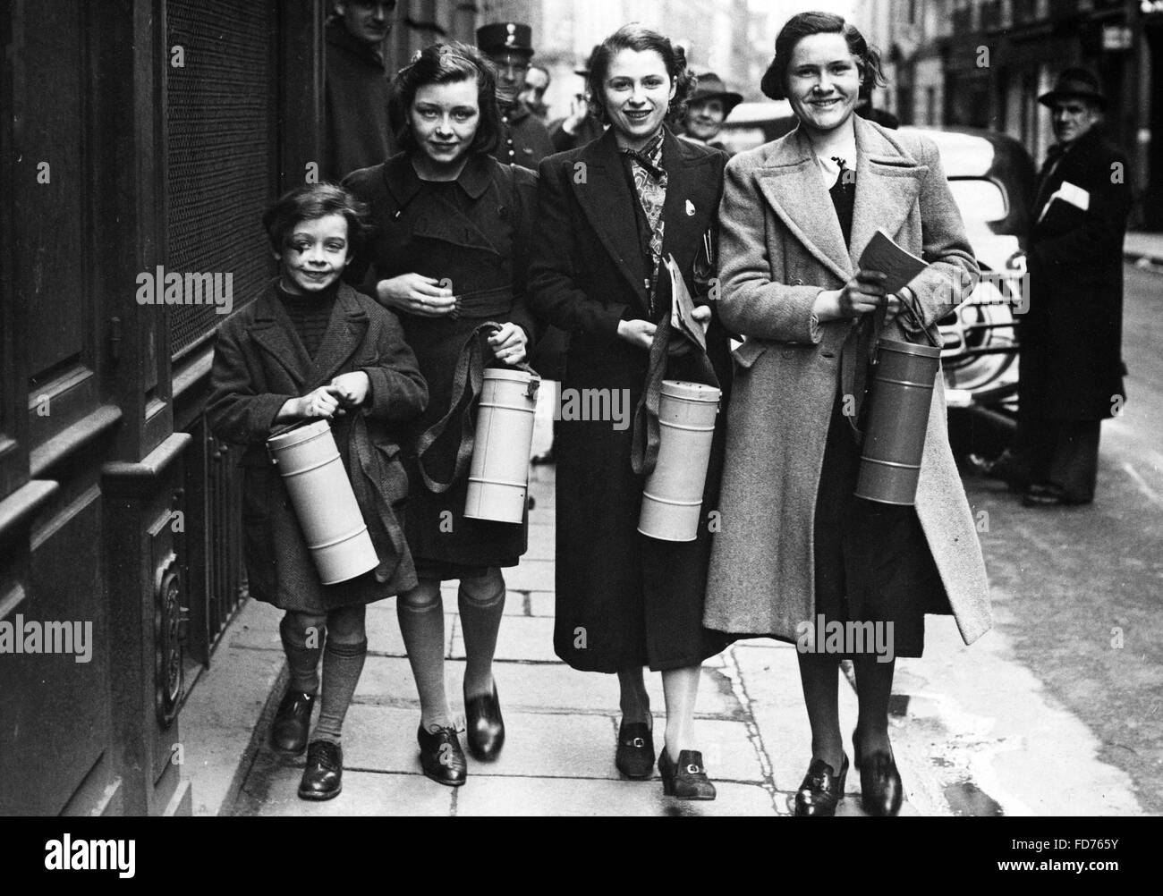 Four young Frenchwomen collecting their gas masks Stock Photo