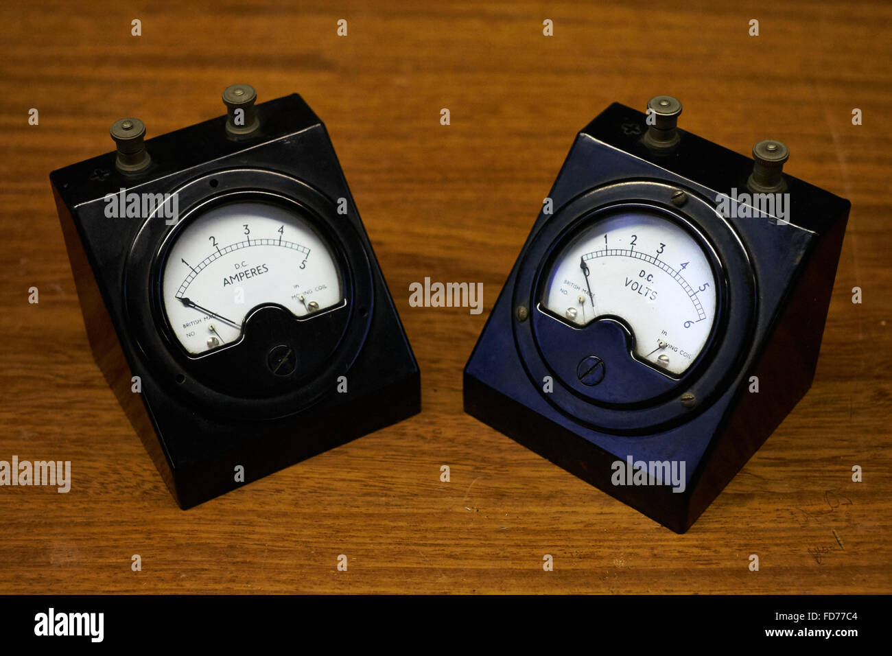 A pair of vintage electrical meters. An ammeter and a voltmeter. Stock Photo