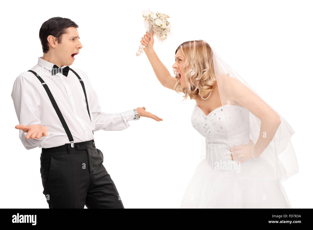 Studio shot of a young bride yelling to the groom and threatening him isolated on white background Stock Photo