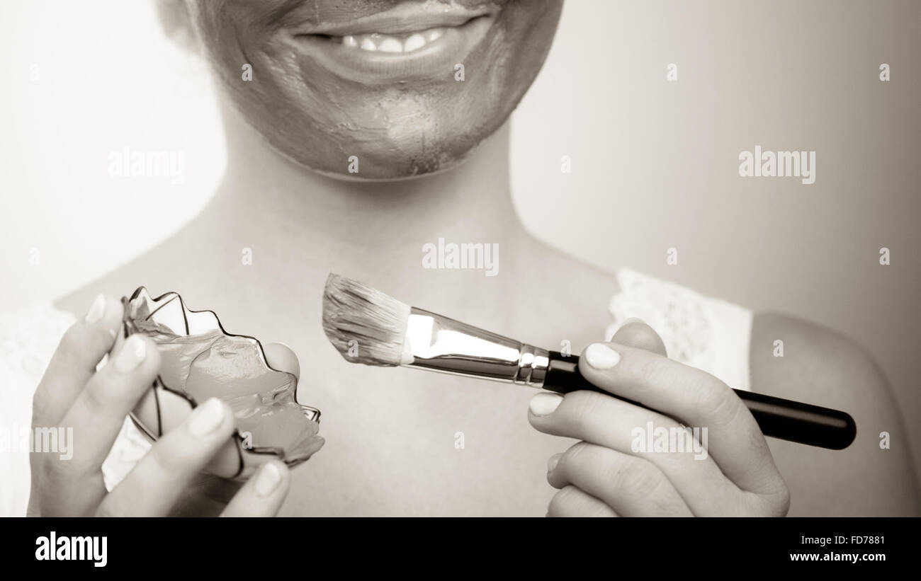 Woman applying brush clay mud hi-res stock photography and images - Alamy