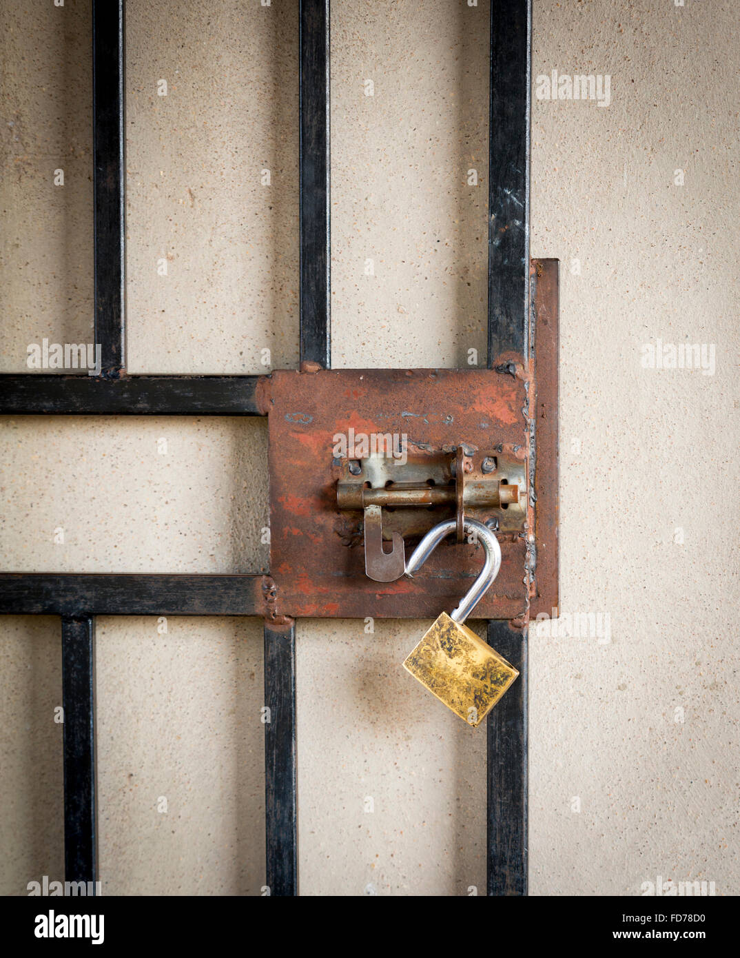 Large metal gate and open padlock on a burglar prevention door in Botswana, Africa Stock Photo