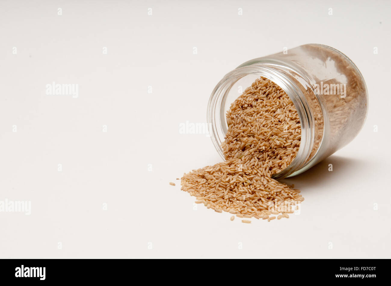 Brown rice being poured from a jar Stock Photo - Alamy