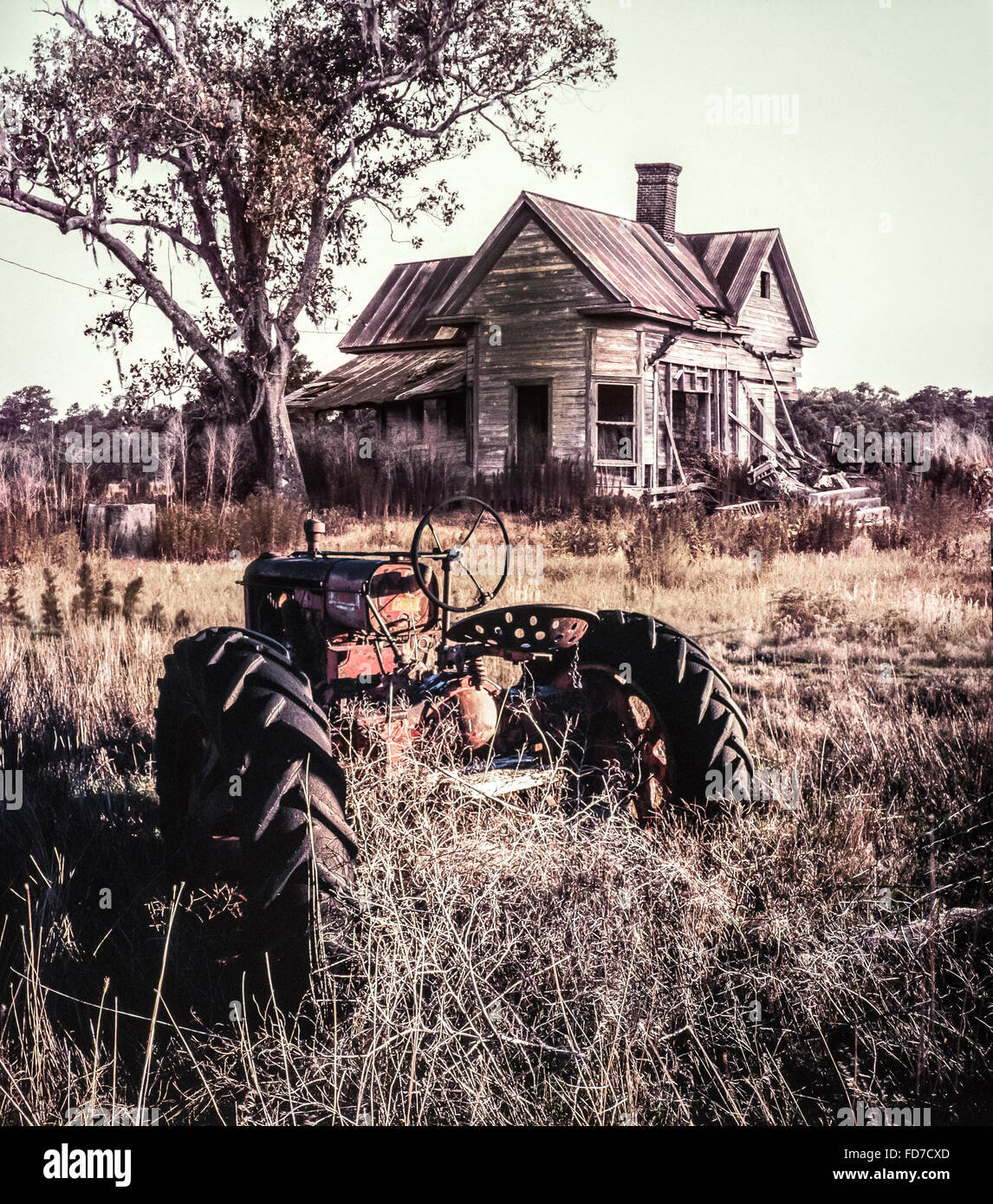 dilapidated farm equipment and abandoned home in ruin Stock Photo