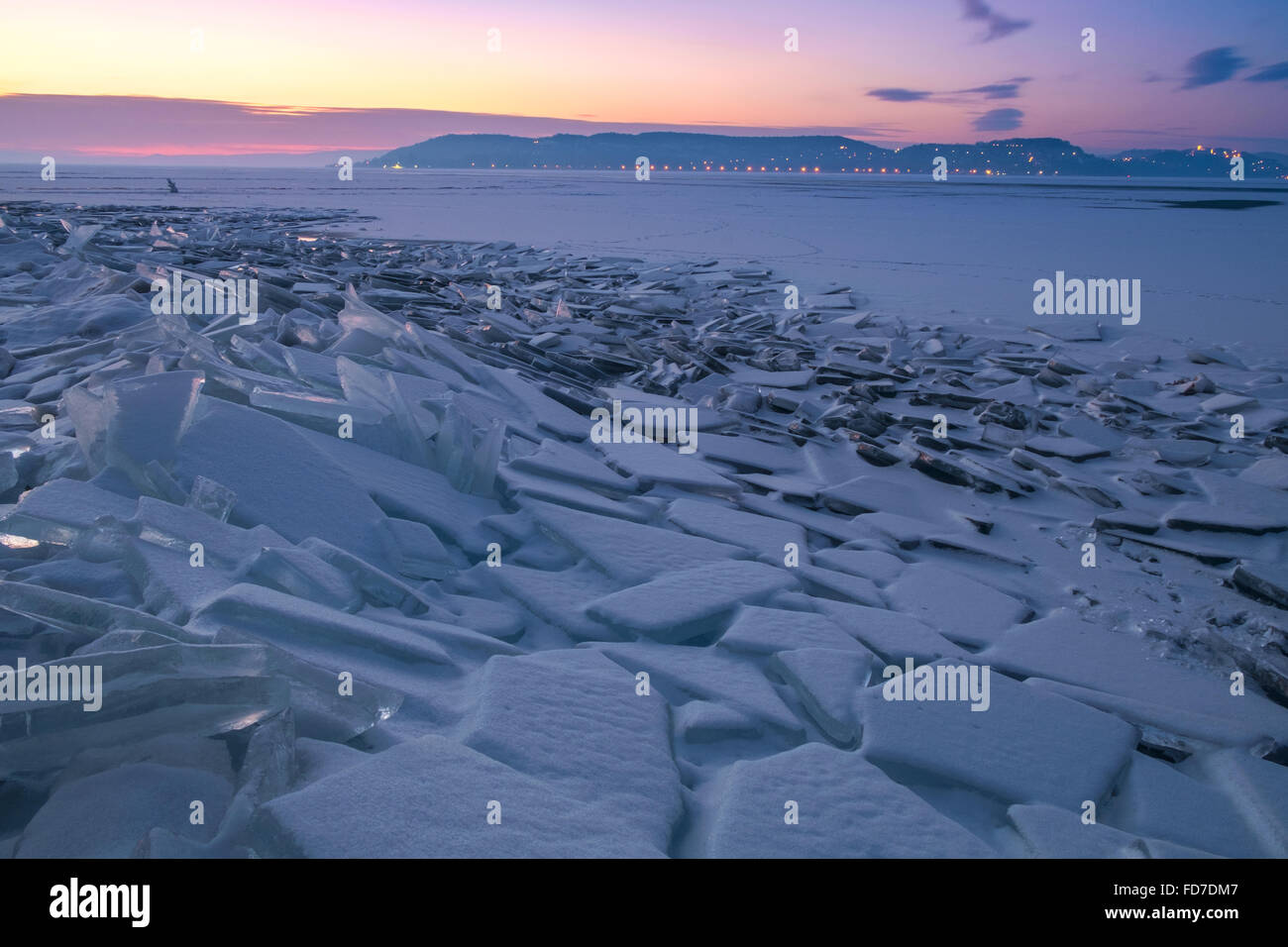 Winter landscape with frozen lake Balaton and sunset sky in Hungary Stock Photo