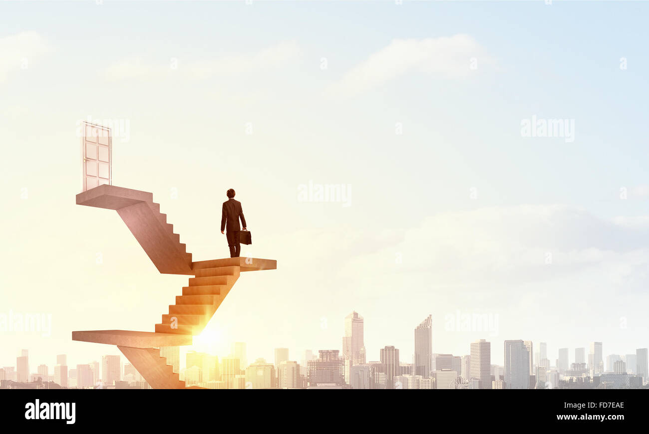 Businessman walking up staircase to door in sky Stock Photo - Alamy