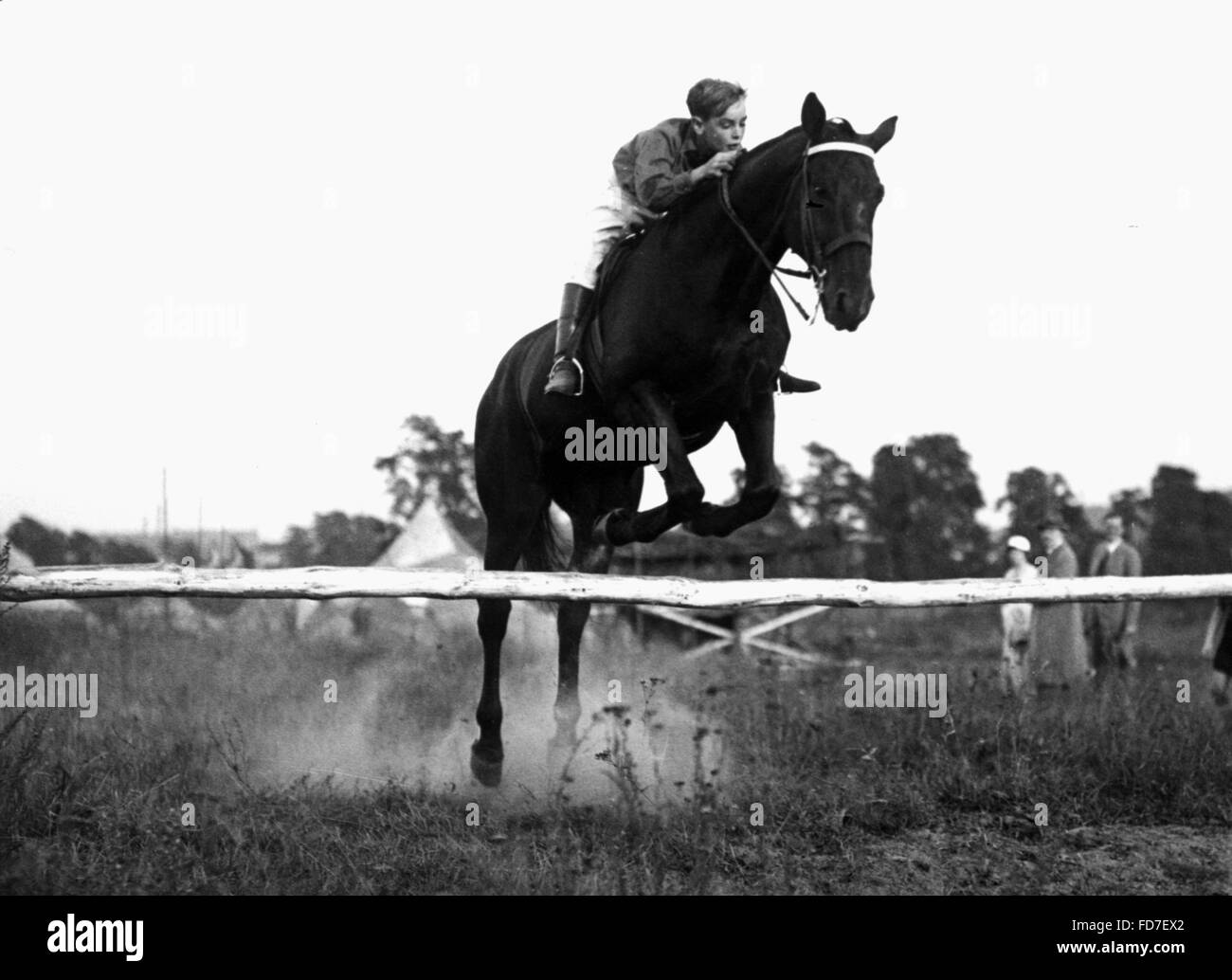 Pimpf with horse jumps over a hurdle, 1933 Stock Photo