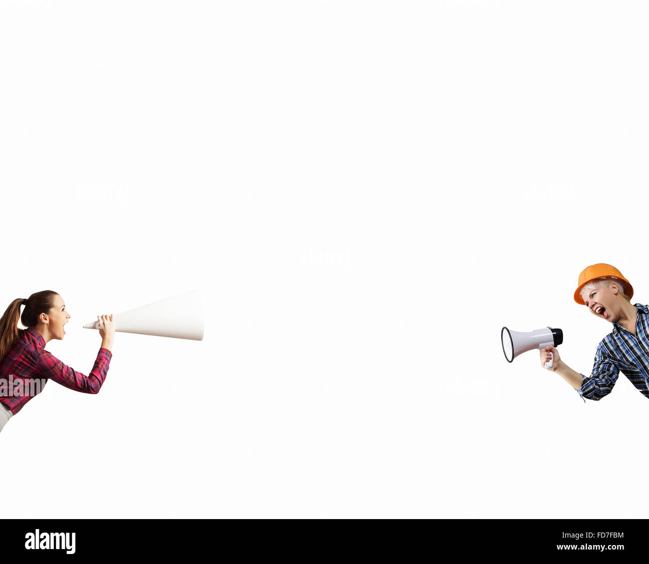 Two business people shouting in megaphones at each other Stock Photo