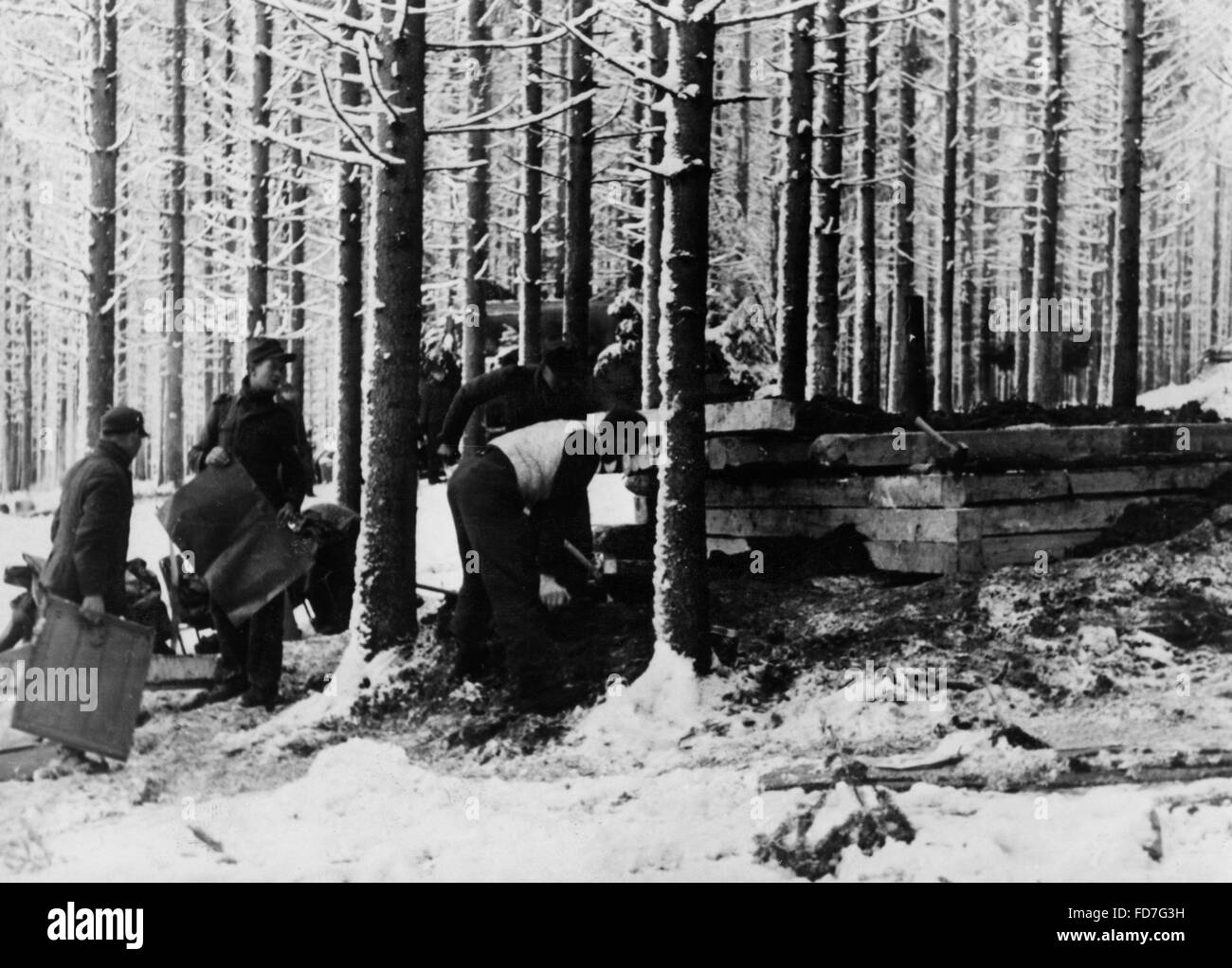 Construction of a wooden bunker during the Battle of the Bulge, 1945 Stock Photo