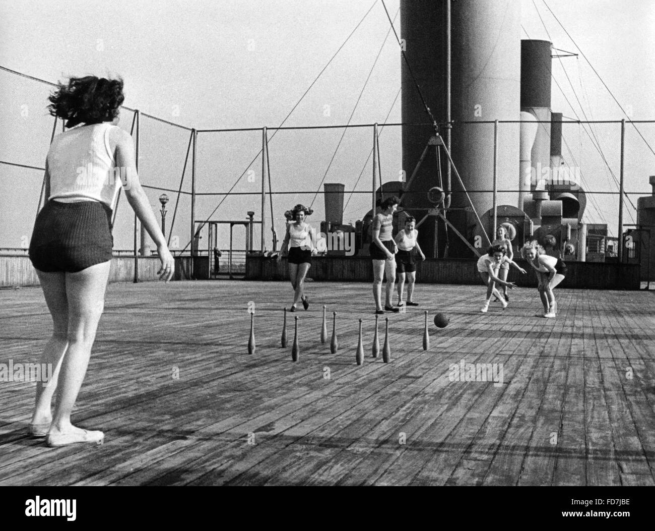 Members of the female auxiliary corps of the Kriegsmarine playing skittles on the deck of a ship, 1943 Stock Photo