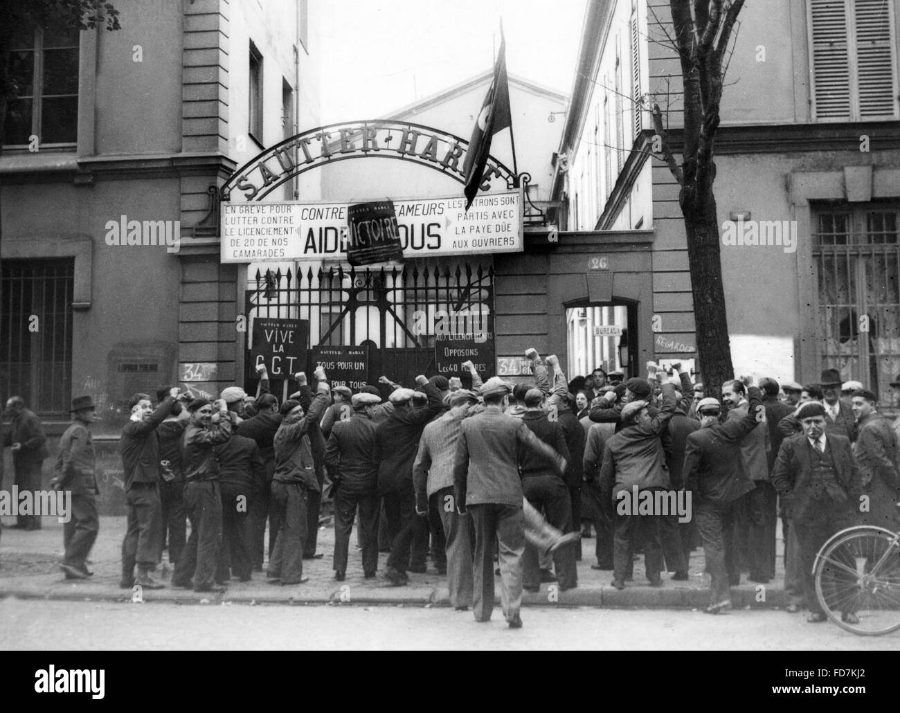 Striking workers give Communist salute in France, 1936 Stock Photo
