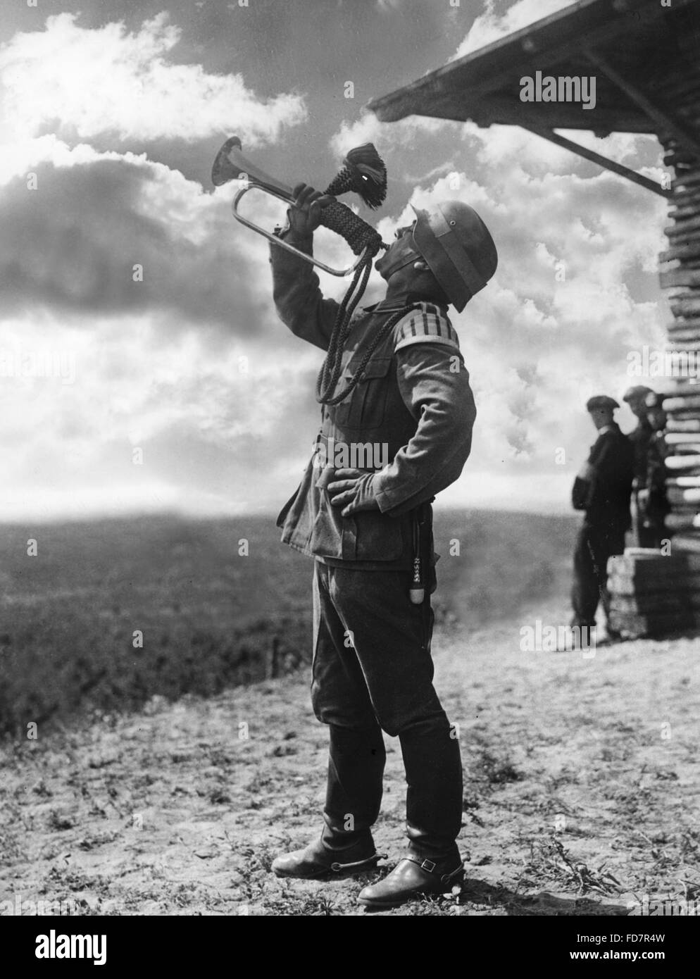 Bugler blows a signal during a maneuver, 1938 Stock Photo