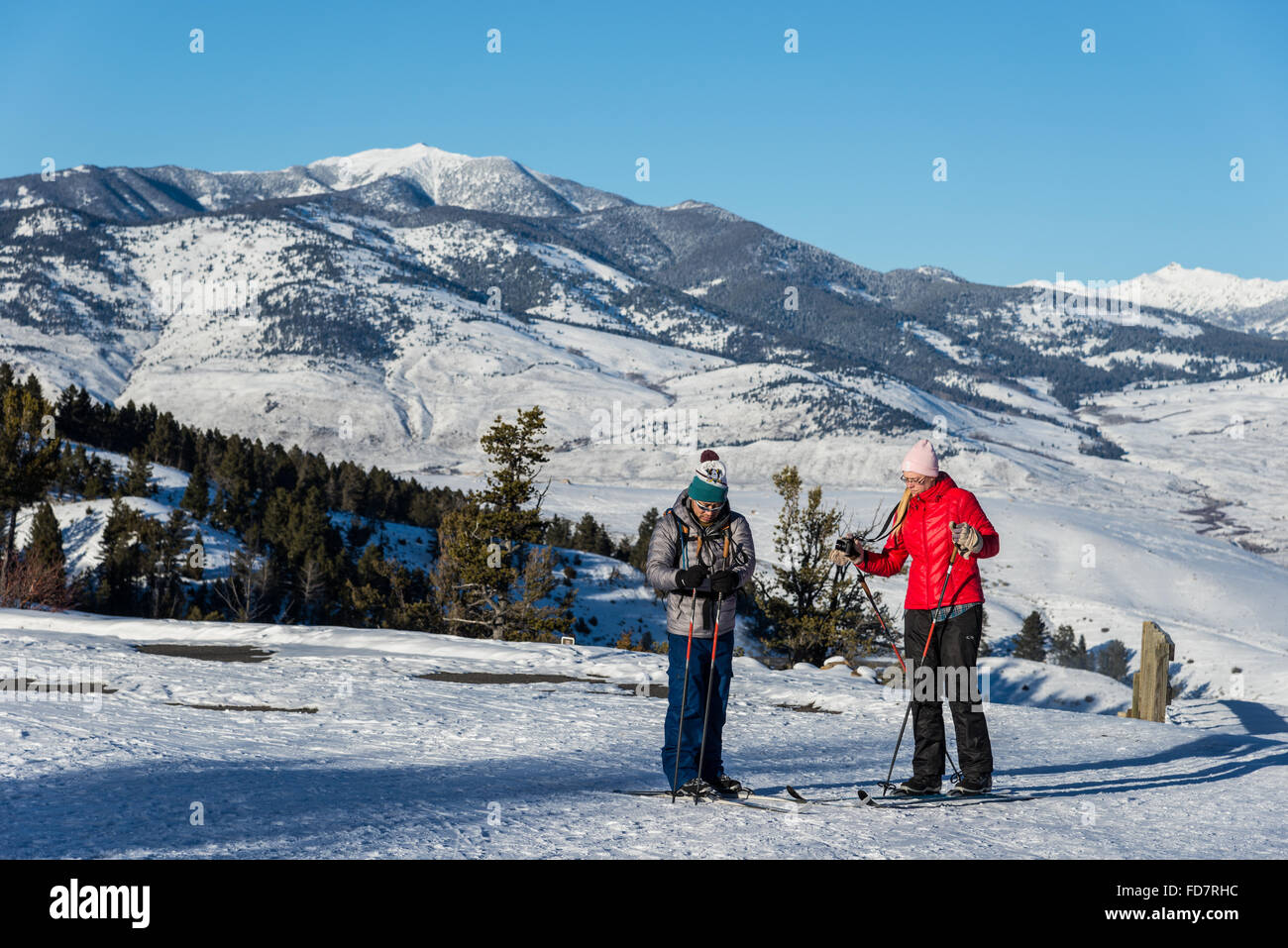 Two cross-country skiers stop to take a picture at Mammoth Hot Springs. Yellowstone National Park, Wyoming, USA. Stock Photo