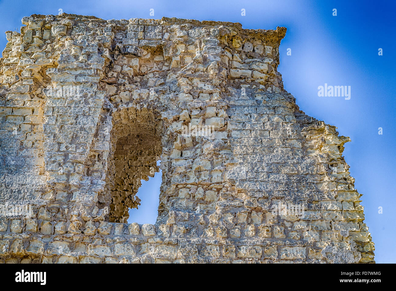 Ruins of ancient watchtower on rocky cove on the coast of Salento in Puglia in Italy Stock Photo