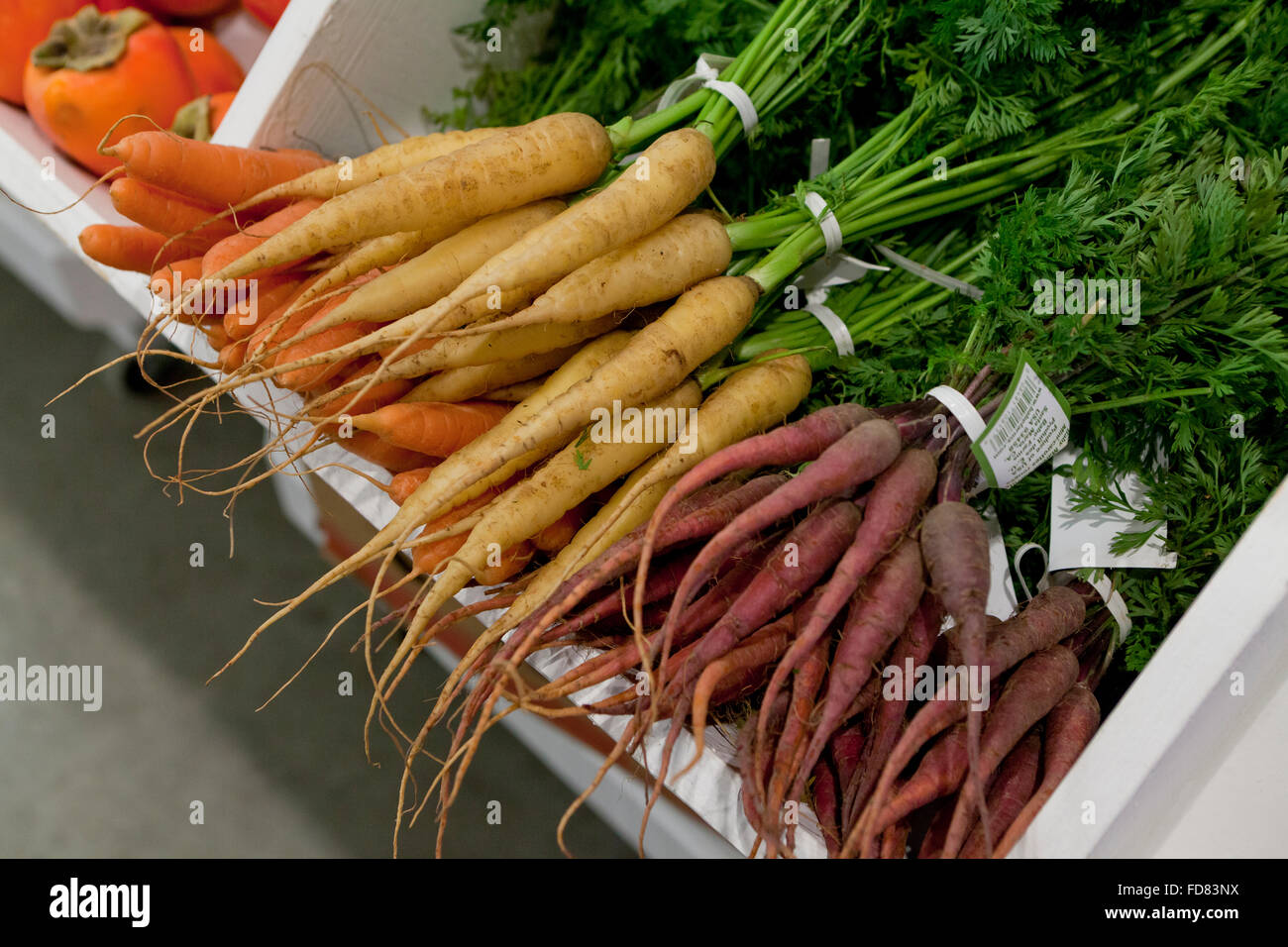 Yellow and red carrot bunches at farmers market - USA Stock Photo