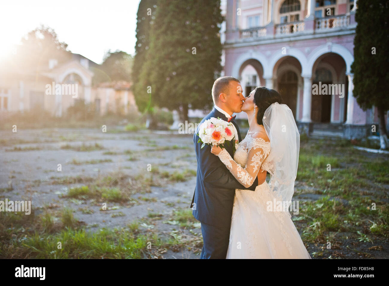 Stylish wedding couple near old vintage pink house with columns Stock ...