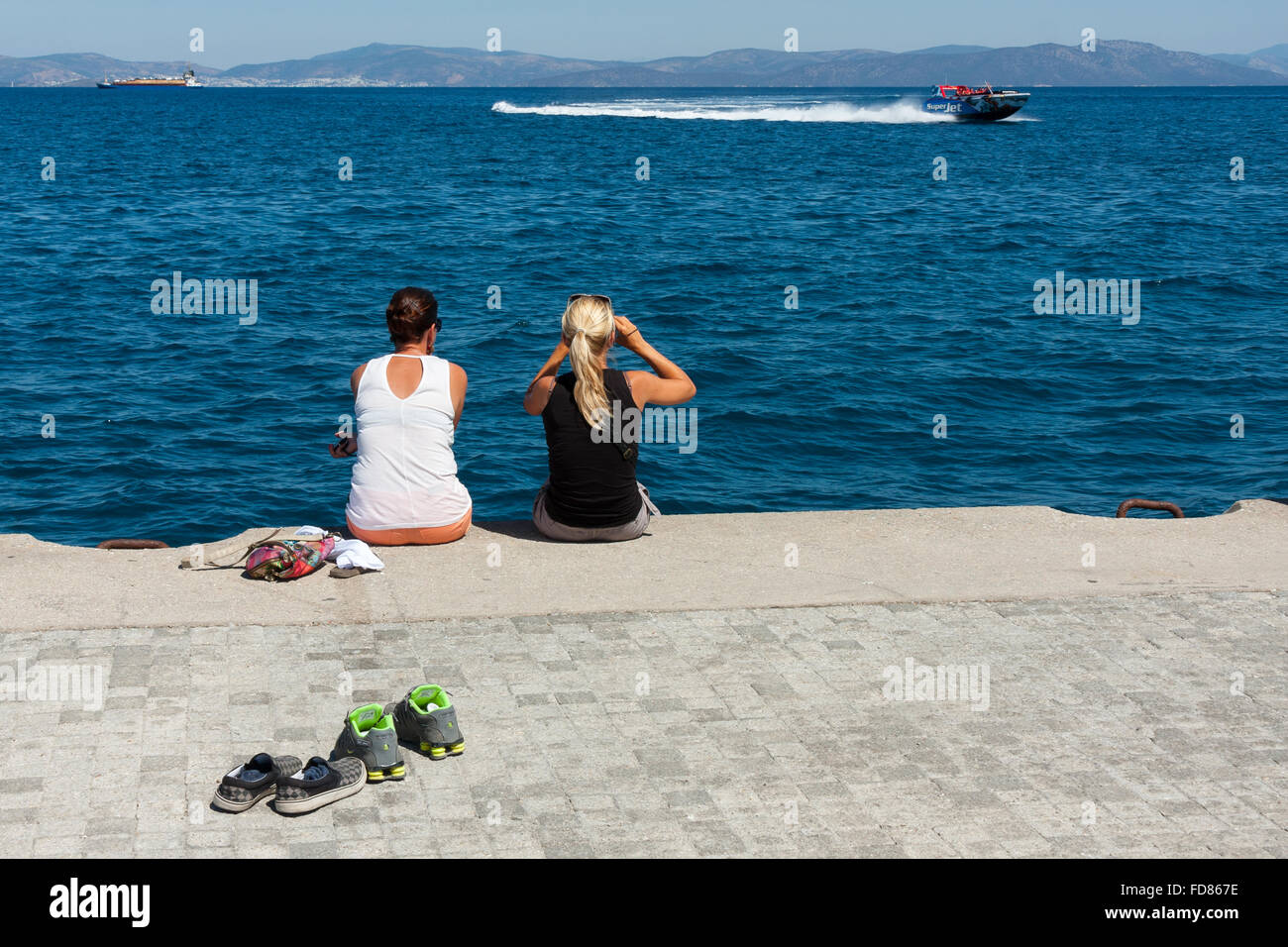 Holidaymakers on Kos looking out towards Turkey Stock Photo