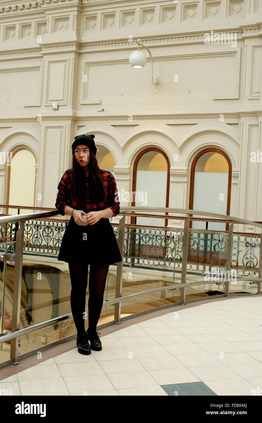 Girl standing on a bridge with glass railings Stock Photo - Alamy
