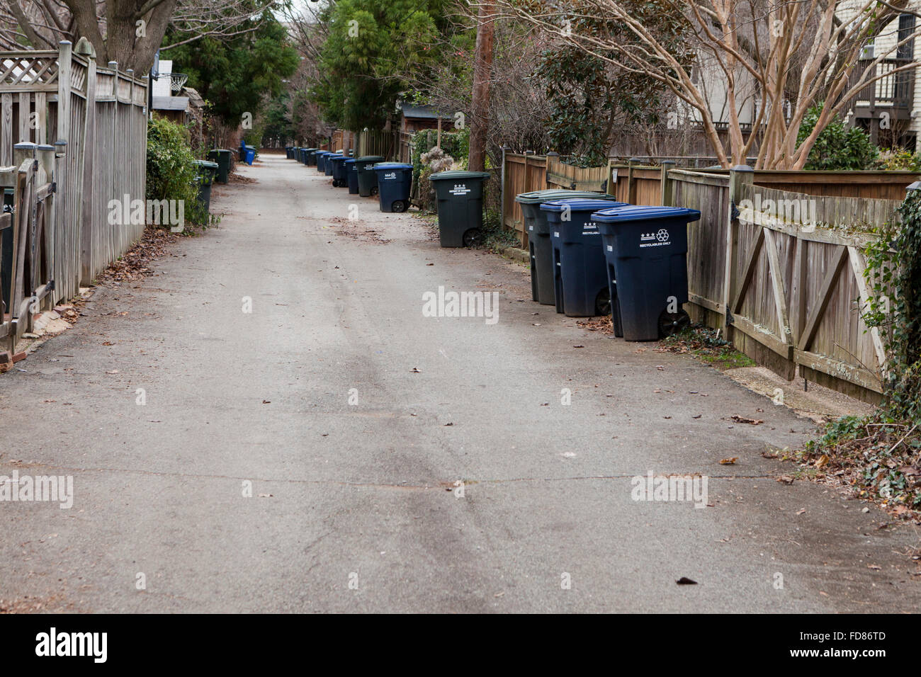 Trash bins in back alley of suburban neighborhood - Maryland USA Stock Photo