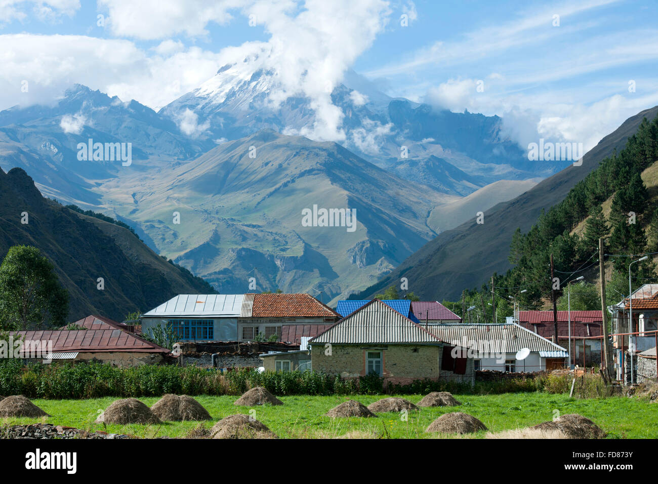 Georgien, Mtskheta-Mtianeti, Häuser der Ortschaft Akhaltsikhe im Sno-Tal südlich von Stepansminda, im Hintergrund der Berg Kazbe Stock Photo