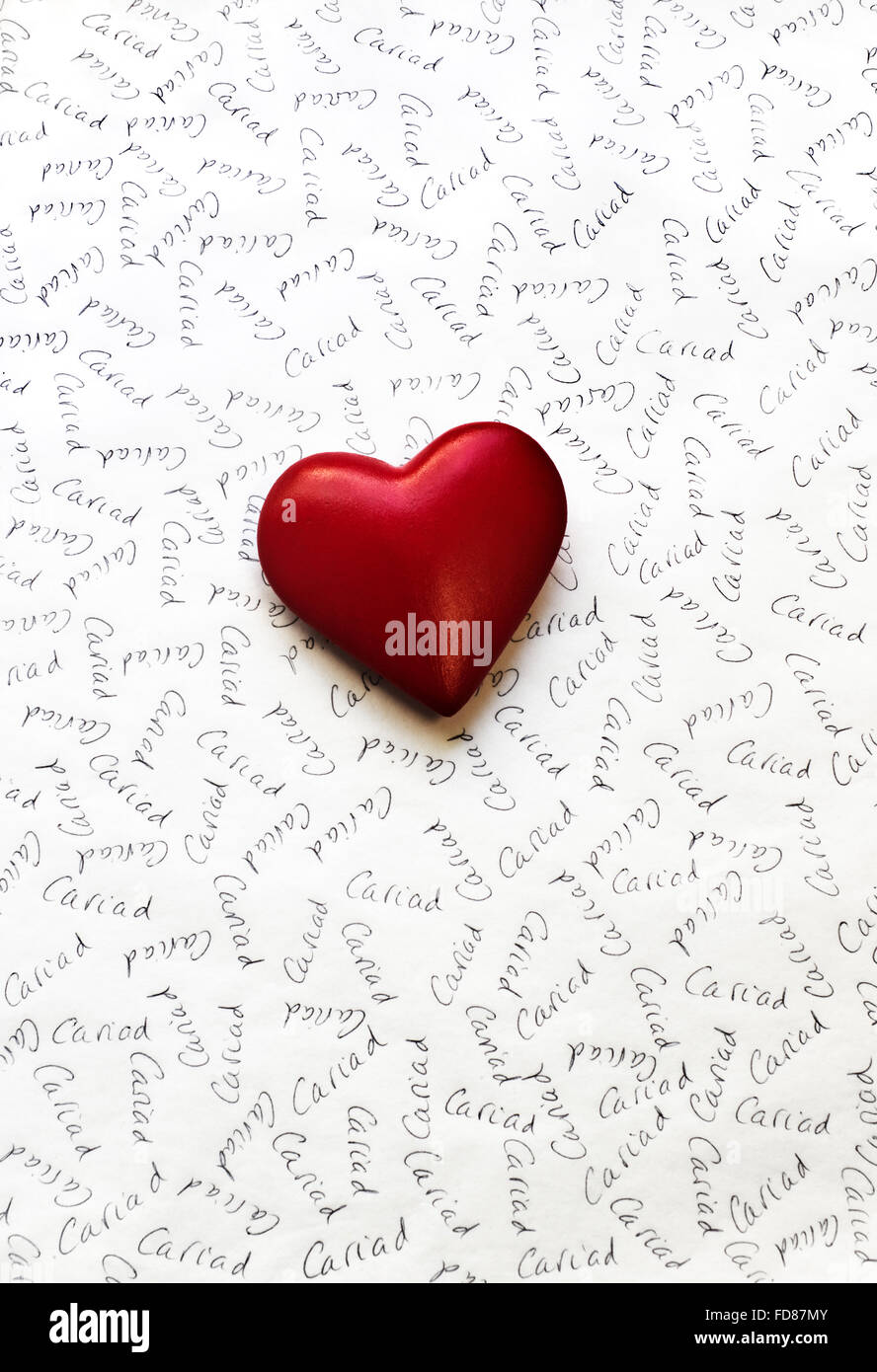 Red heart on white paper inscribed with Cariad, the Welsh word for Love Stock Photo