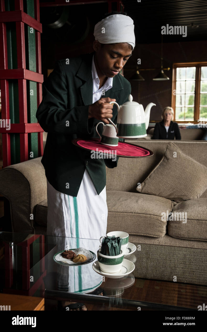 A tea boy a member of the hotel staff,  serving locally grown tea at the 4-star Heritance Tea Factory hotel above Nuwara Eliya in Central Province of Stock Photo