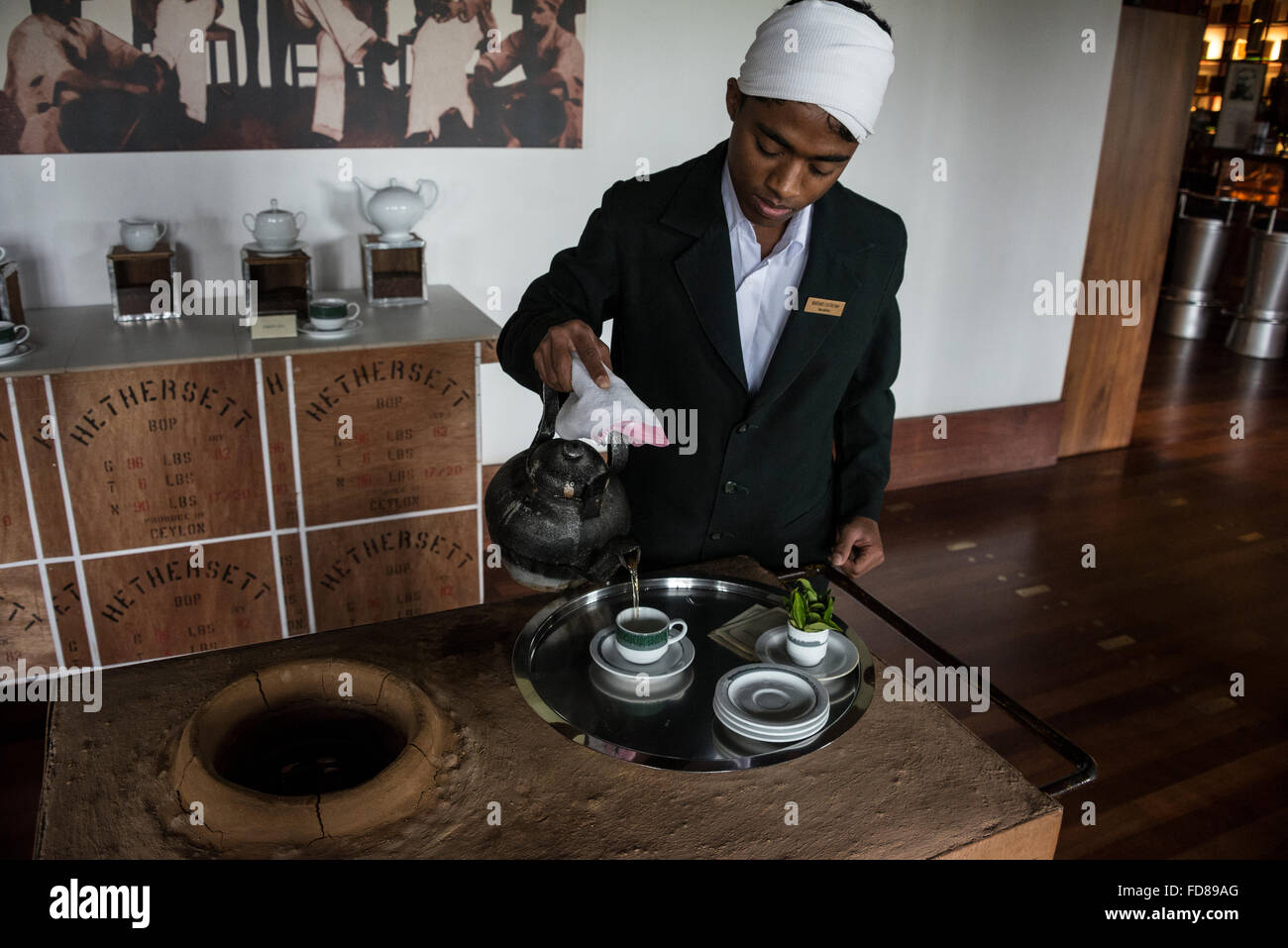 A tea boy serving home produced tea at the 4star Heritage Tea Factory