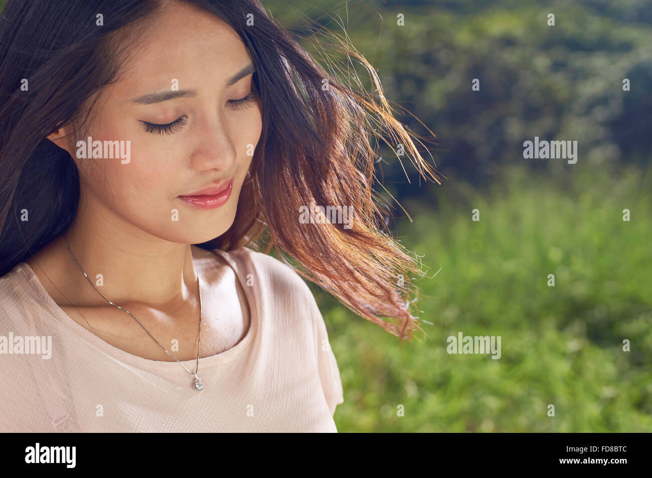 young Chinese beauty in nature, smiling with eyes closed Stock Photo ...