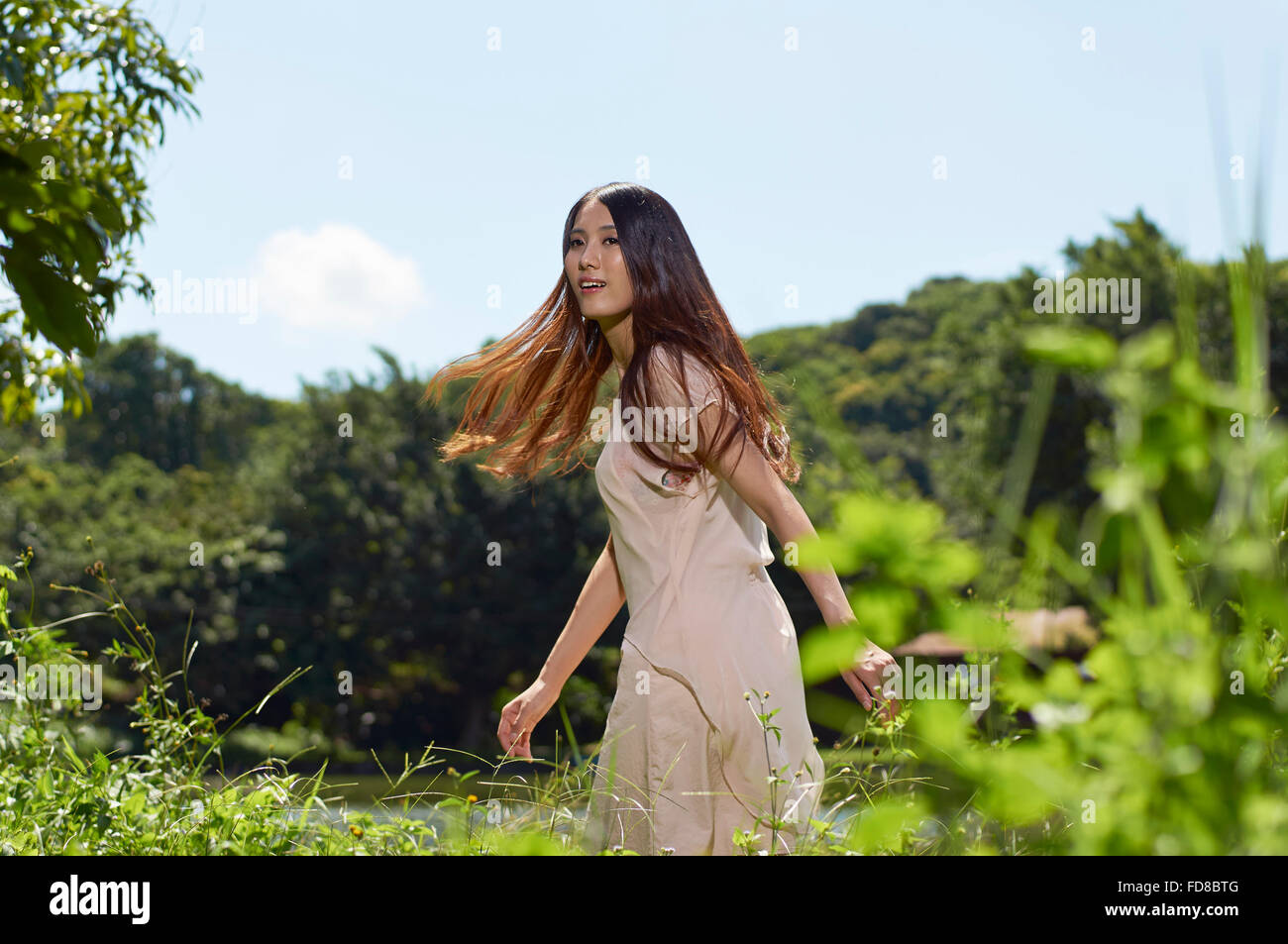 young Chinese beauty dancing in nature Stock Photo