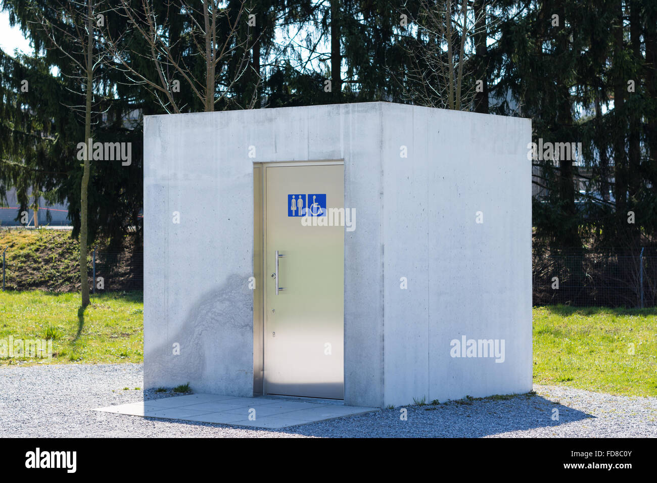A cube shaped WC in a park. Simple design and construction Stock Photo