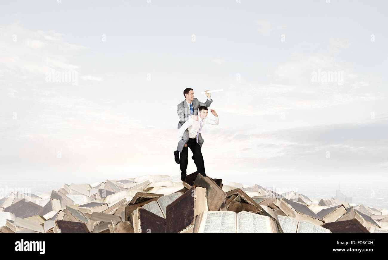 Businessman riding on back of his colleague Stock Photo - Alamy