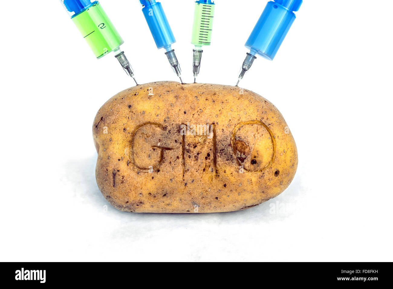 Potato with syringes (genetic modification concept) Stock Photo
