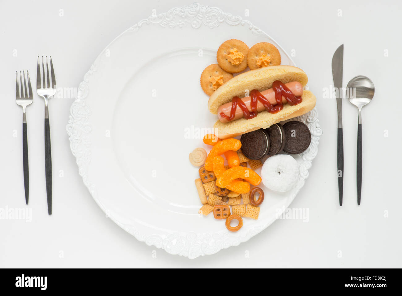 half a plate filled with processed unhealthy foods Stock Photo
