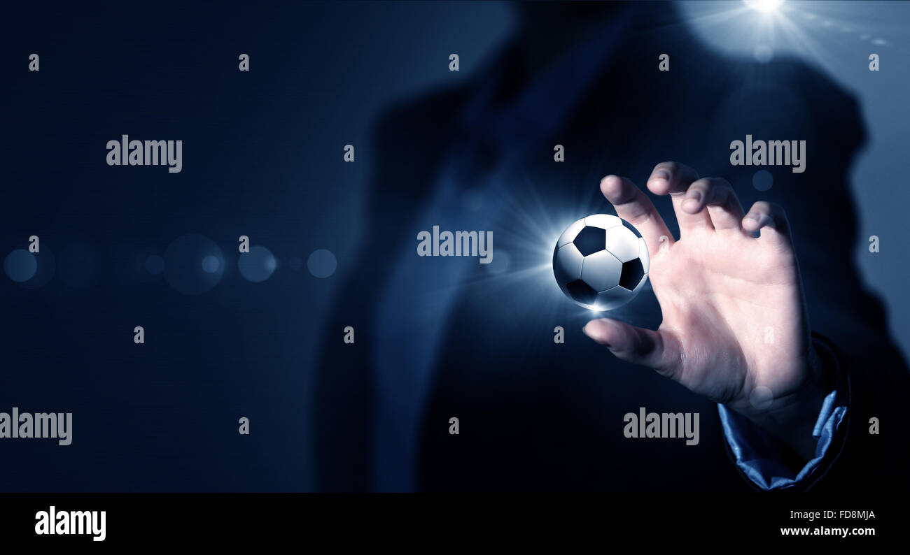Close up of elegant businessman holding soccer ball in hand Stock Photo ...