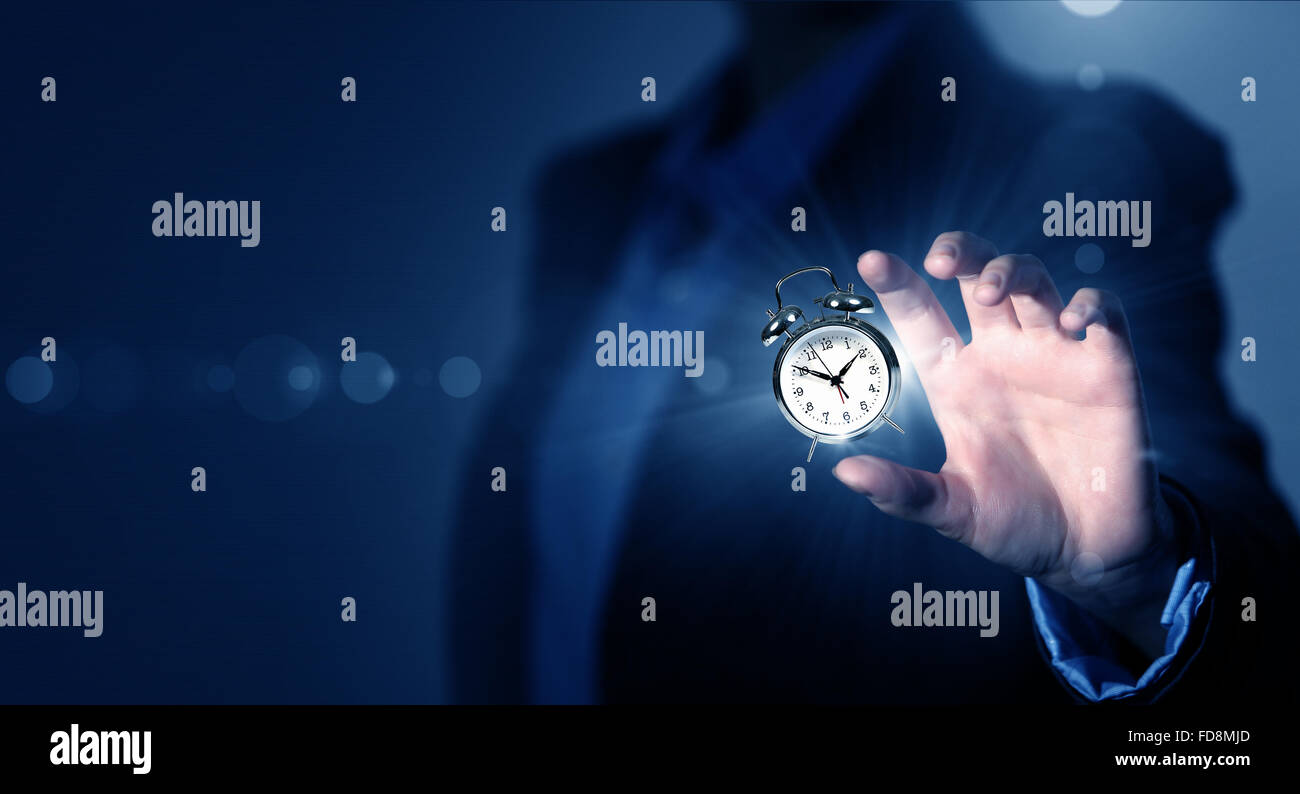 Close up of businessman hand showing clock watch symbol Stock Photo - Alamy
