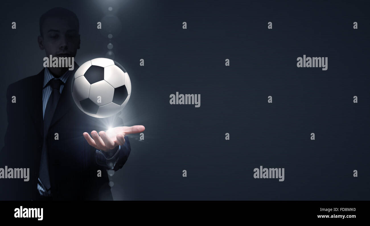 Close up of elegant businessman holding soccer ball in hand Stock Photo ...