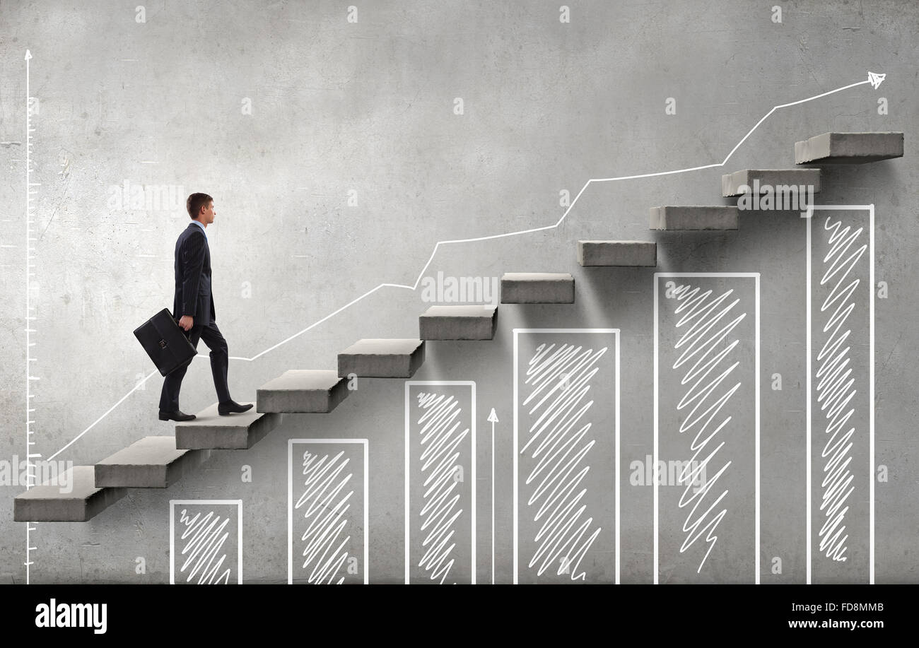 Young businessman walking up on staircase representing success concept ...