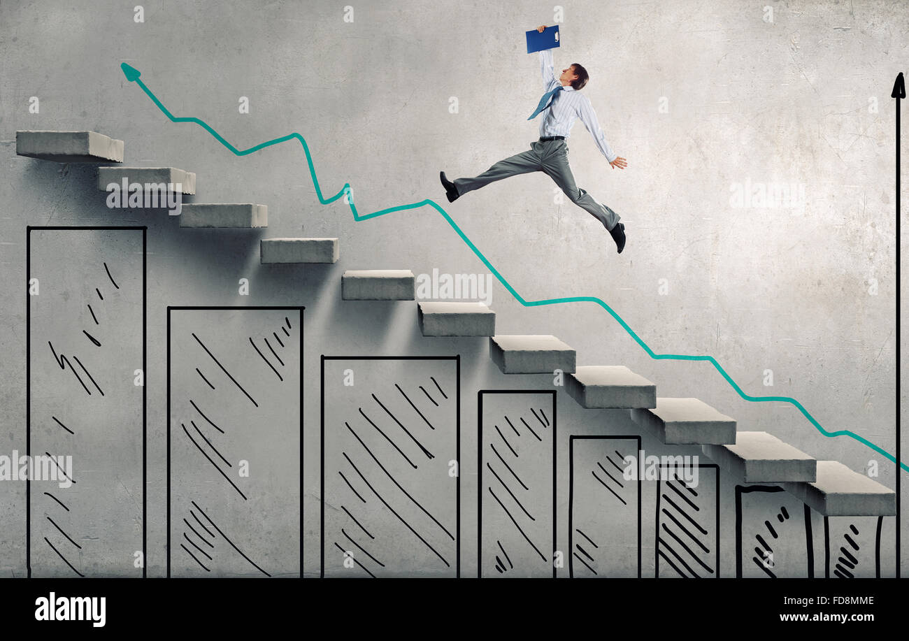 Young businessman walking up on staircase representing success concept ...