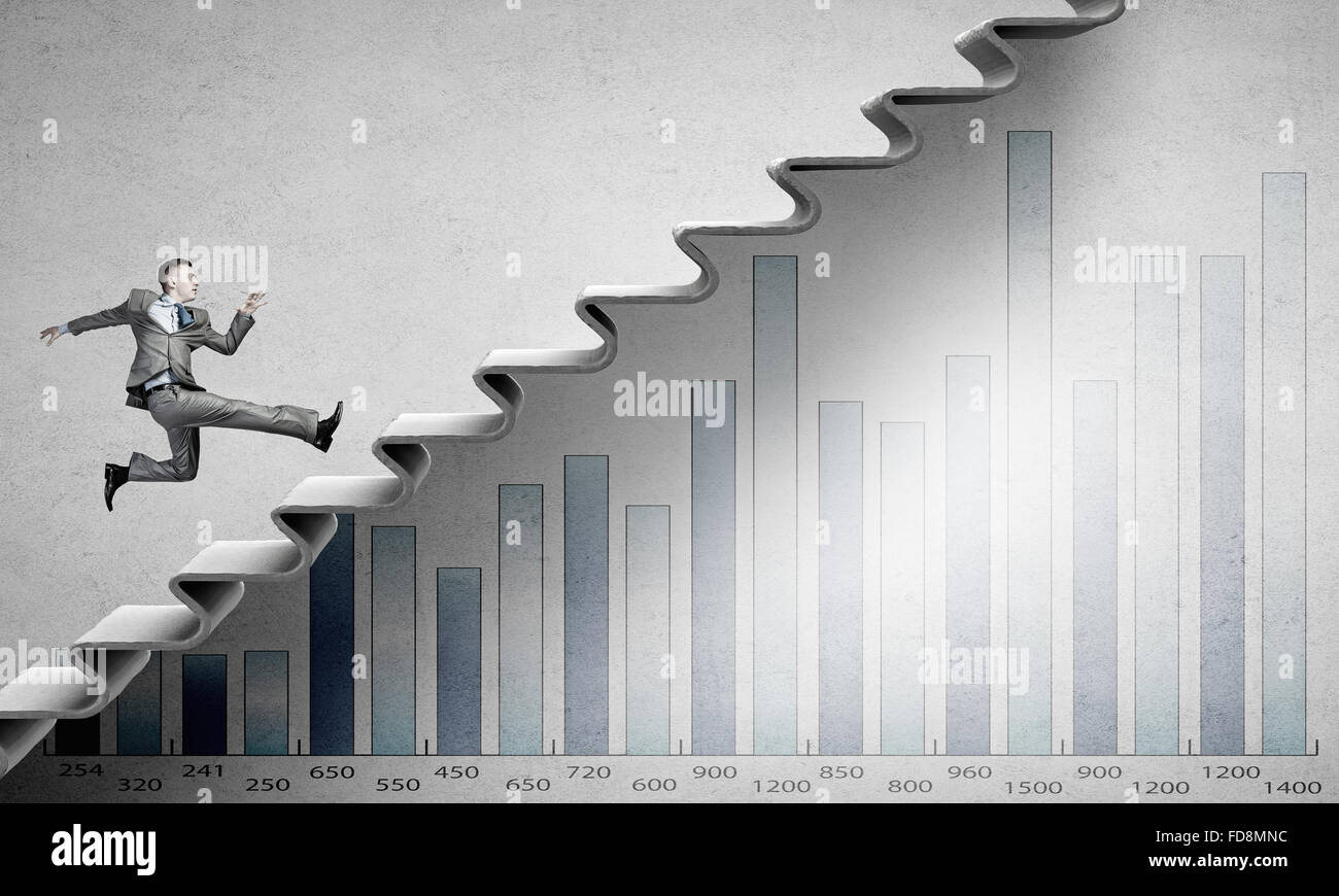 Young businessman walking up on staircase representing success concept ...